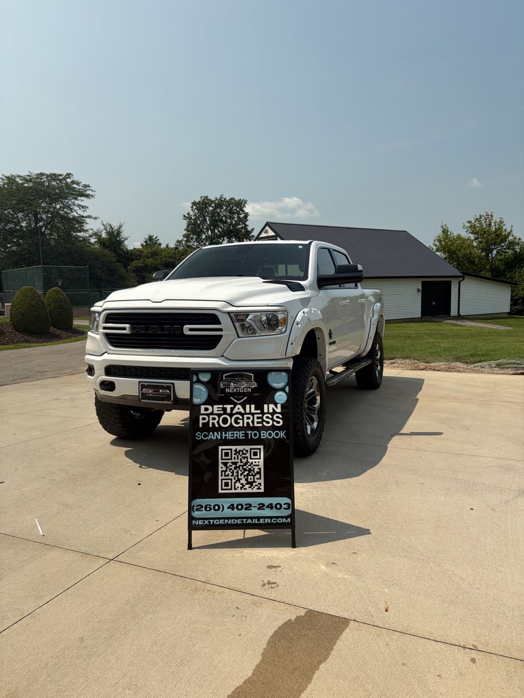 Lifted white RAM truck freshly detailed on site