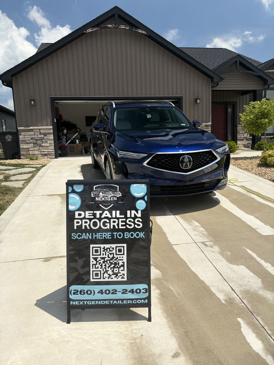 Blue Acura SUV freshly detailed in a customer driveway